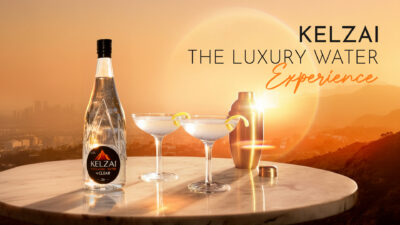 Kelzai Luxury Water in glass bottle on fine dining table with crystal stemware and gourmet plating